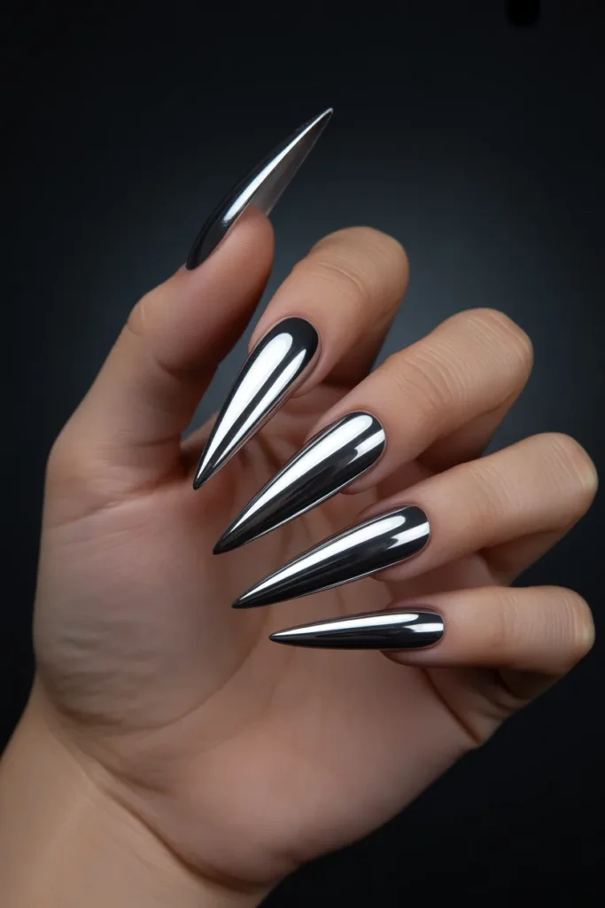 10. Long Black Stiletto Nails with Chrome Mirror Finish