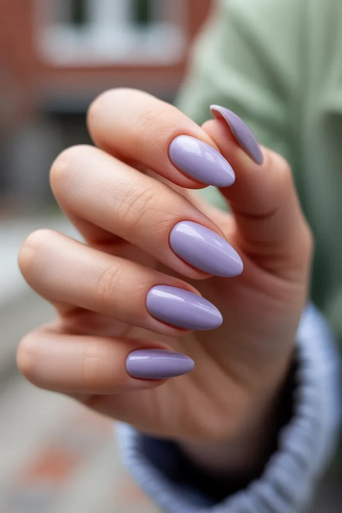 beauty editorial photo of short almond nails painted in barely-there lavender polish, sheer pastel milky finish, soft natural skin tone hands, clean manicure