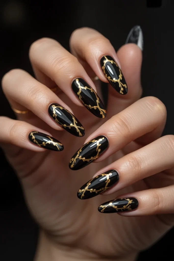 16. Black Acrylic Nails with Gold Chain Nail Art