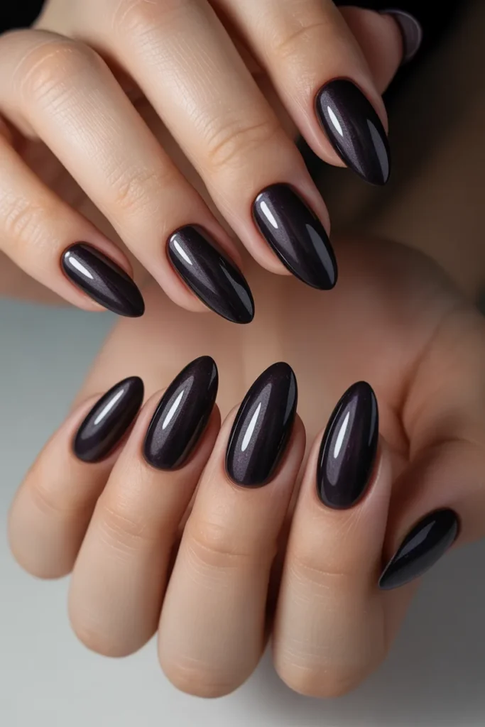 21. Matte Black Almond Nails with Subtle Shimmer