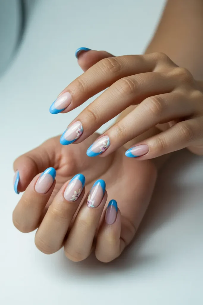 3. Sky Blue French Tips With Floral Accents