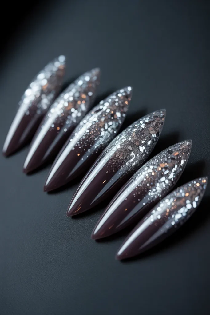 6. Black and Silver Glitter Ombre Stiletto Nails