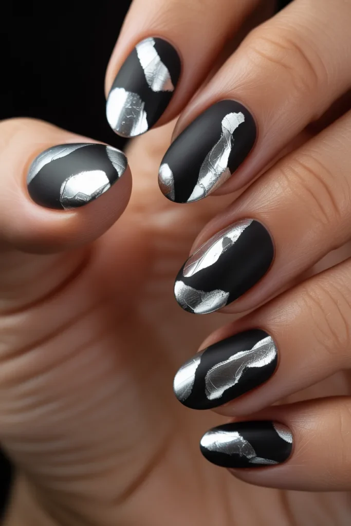 8. Short Almond Black Nails with Silver Foil Art