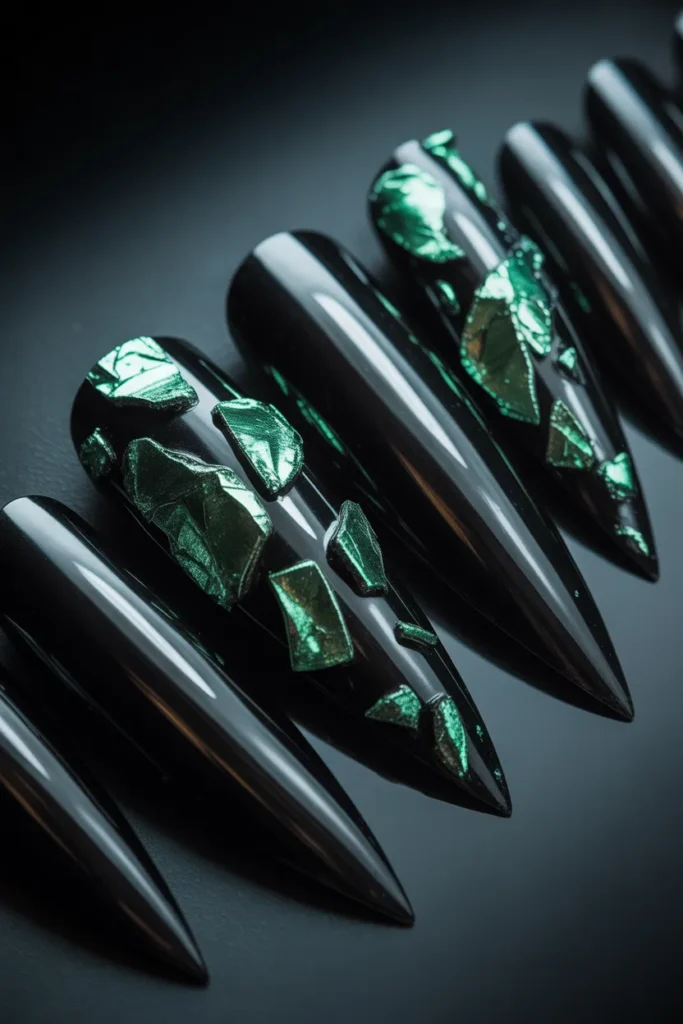 5. Black Stiletto Nails with Green Foil Art
