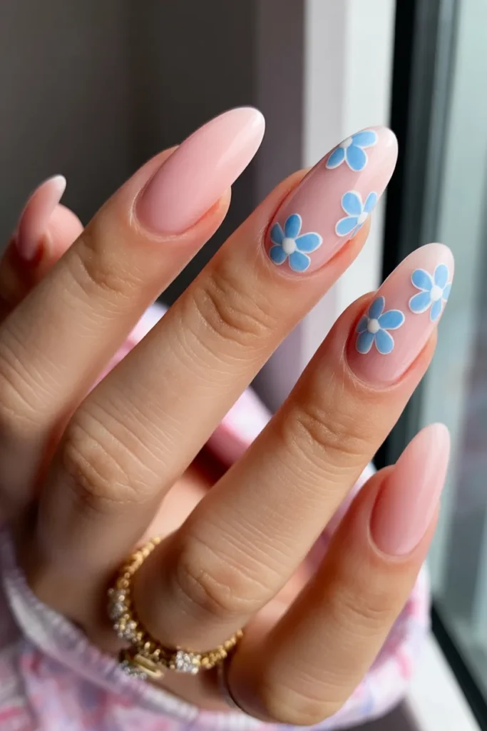 2. Pink Almond Nails With Blue Flower Art