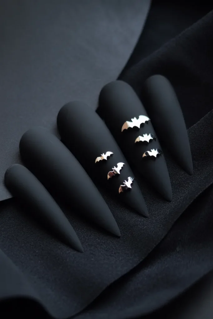 5. Goth Stiletto Nails with Chrome Bat Details