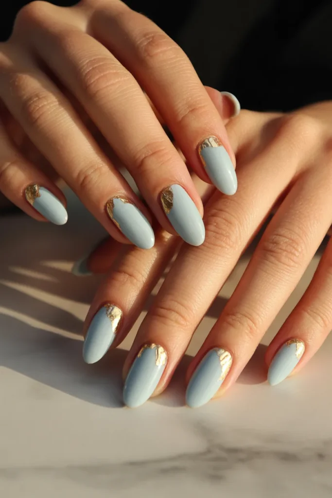 7. Light Blue Nails with Subtle Gold Details
