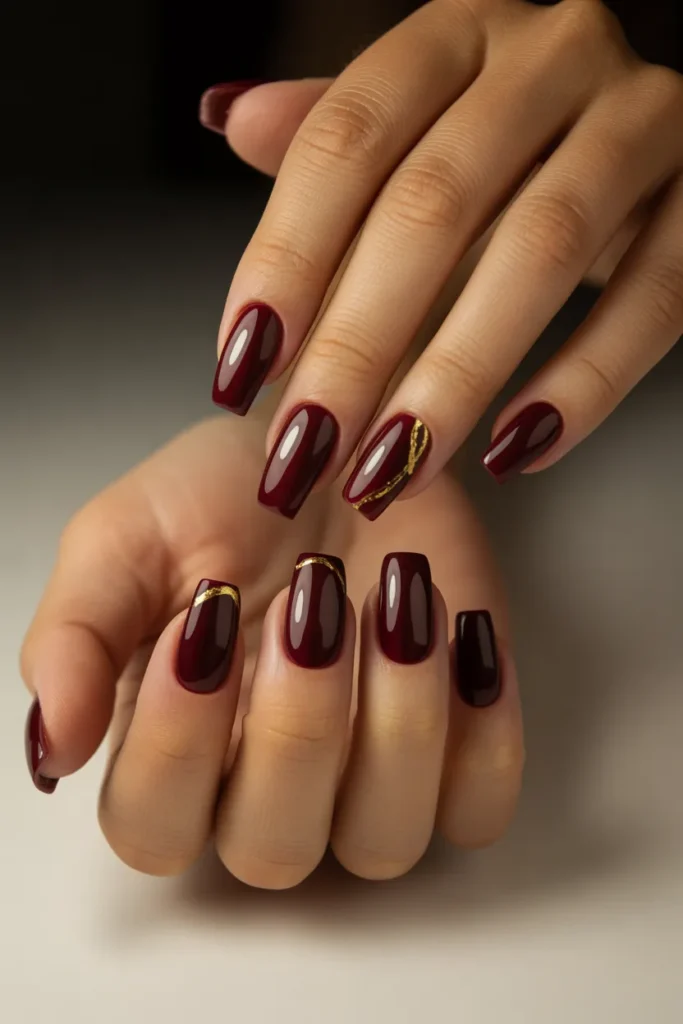 12. Burgundy Wine Red Nail Designs — Gold Accent Lines