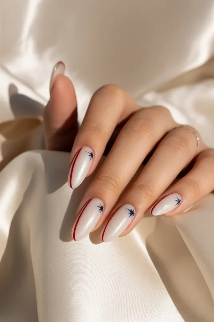 16. Luxe White Almond Nails with Red and Navy Micro Art